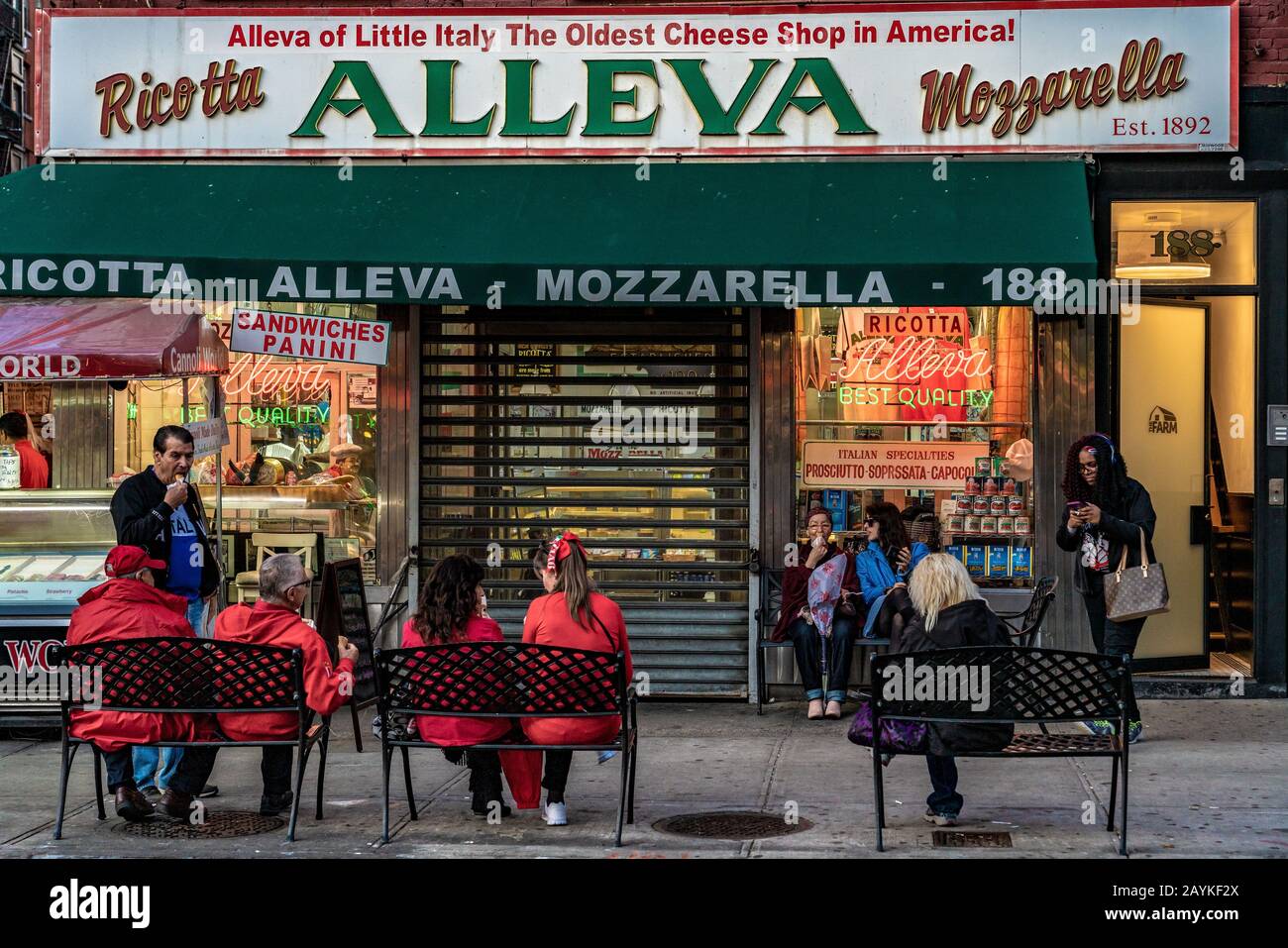 NEW YORK, USA - OCTOBER 14: This is a street scene of people sitting outside Alleva, the oldest cheese shop in America on October 14, 2019 in New York Stock Photo