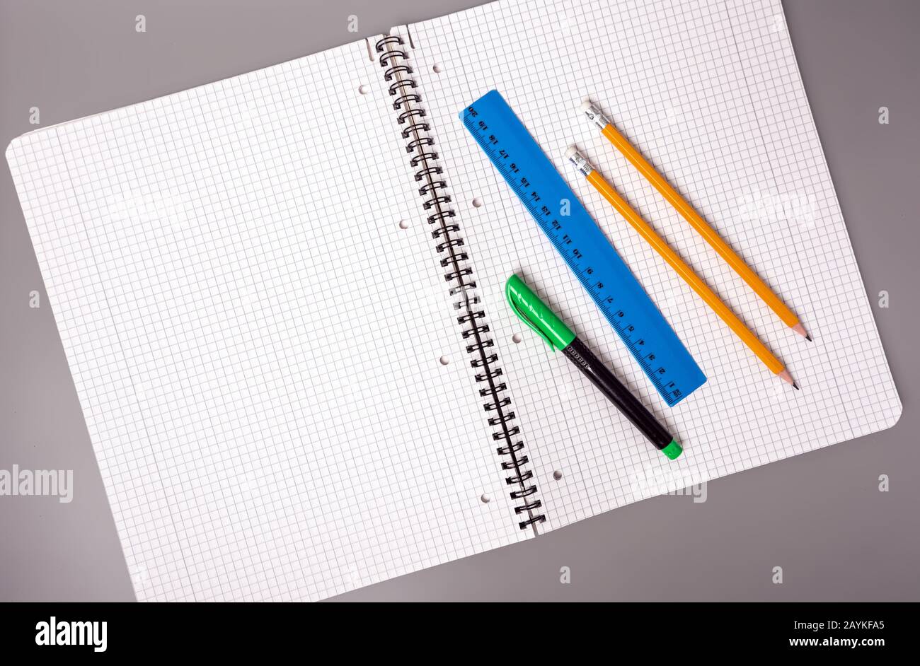 Pencils, pen and ruler are on an open notebook. Office. School supplies. Stock Photo