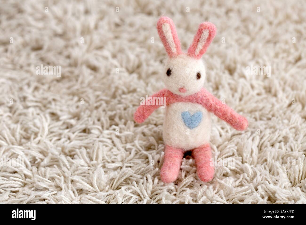 handmade felted rabbit on white carpet Stock Photo Alamy