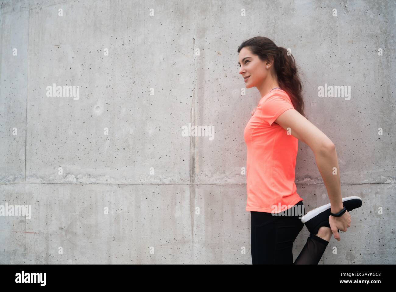 Athletic woman stretching legs hi-res stock photography and images - Alamy