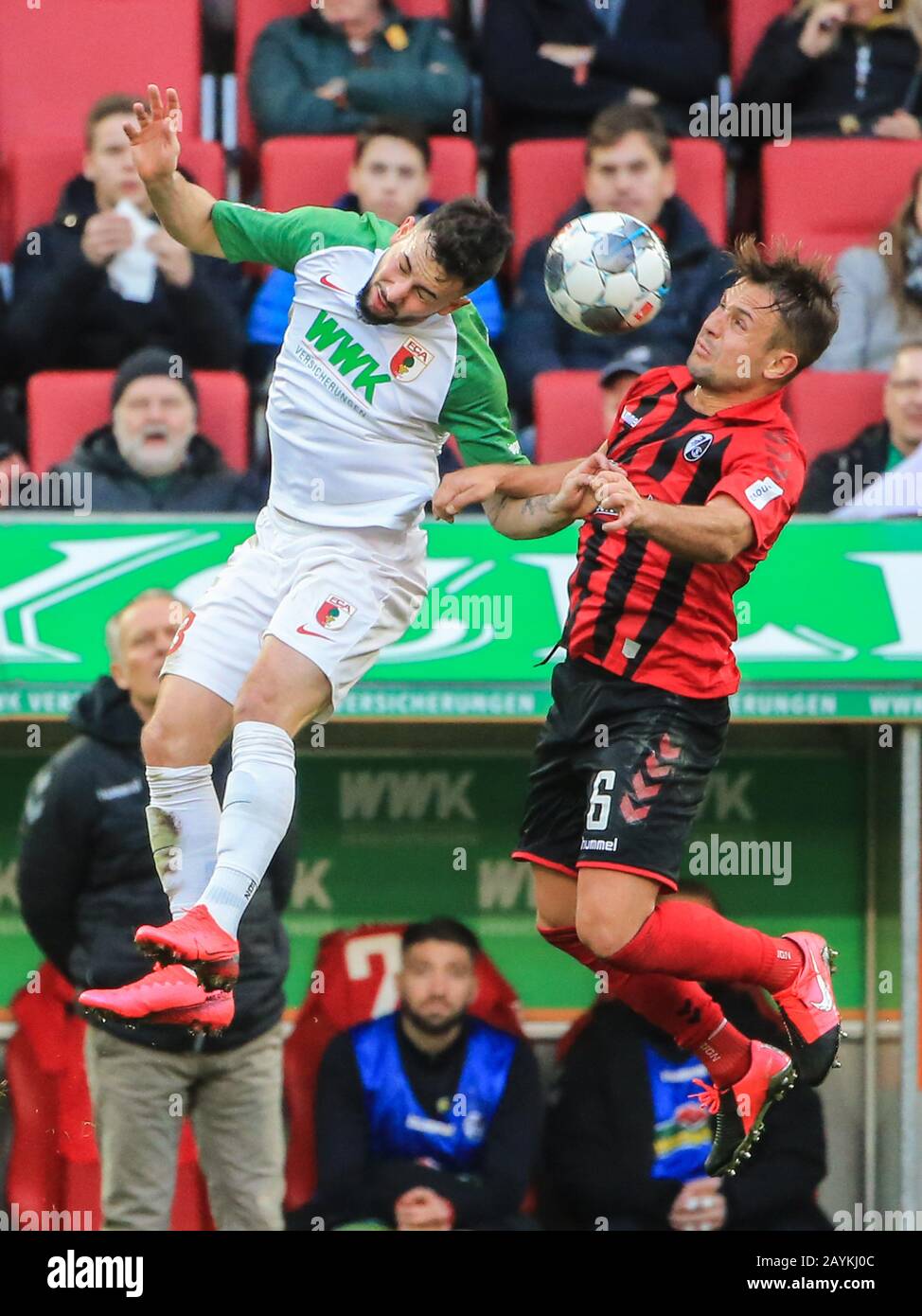 Augsburg, Germany. 15th Feb, 2020. Marco Richter (L) of Augsburg vies for header with Amir Abrashi of Freiburg during a German Bundesliga match between FC Augsburg and SC Freiburg in Augsburg, Germany, Feb. 15, 2020. Credit: Philippe Ruiz/Xinhua/Alamy Live News Stock Photo
