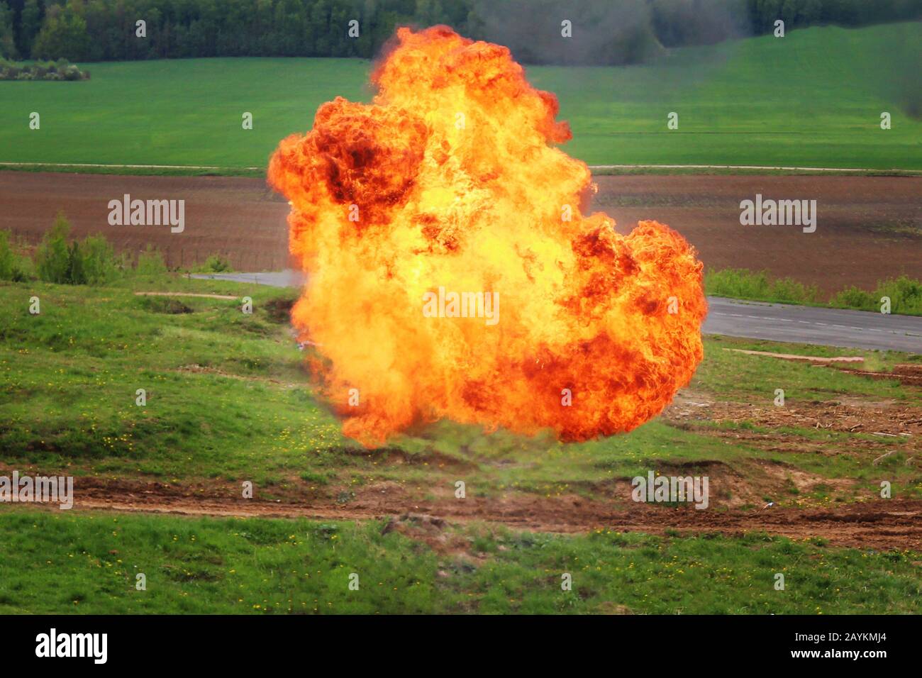Gas explosion on the outskirts of the forest near the road. A fireball and flames rise into the