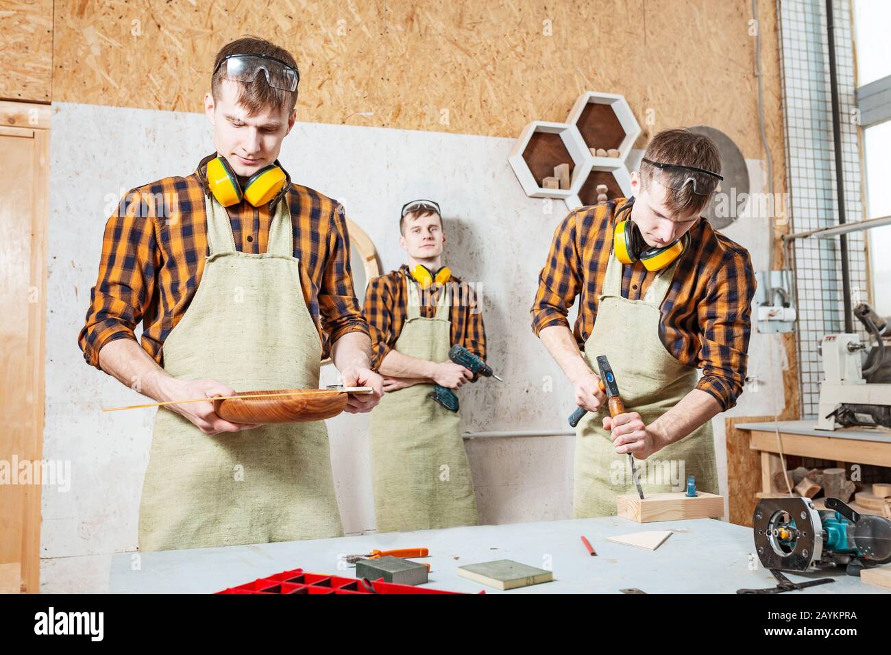 Carpenter worker divided and performs work in three independent persons Stock Photo