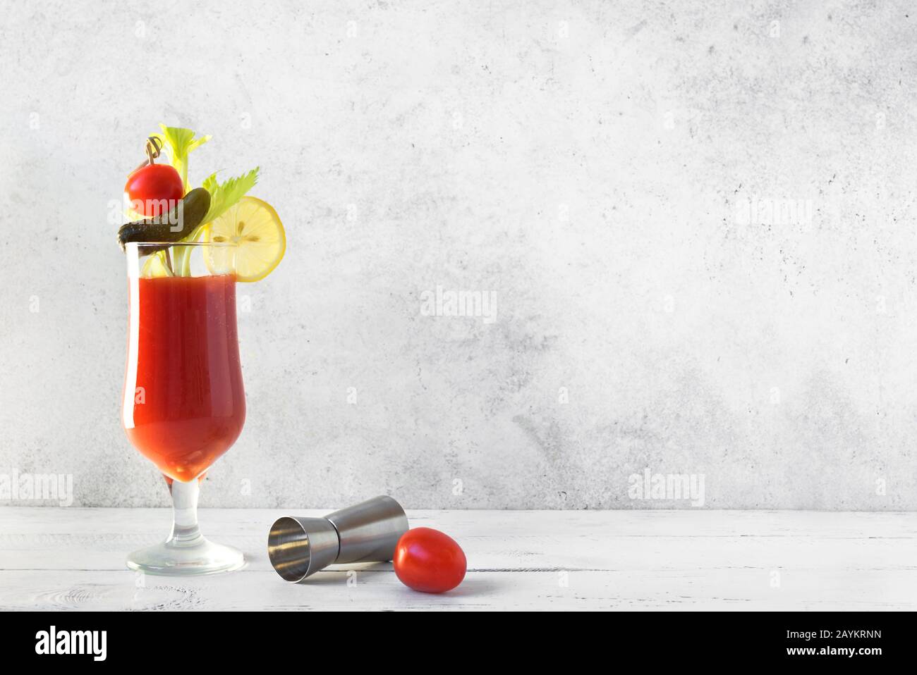 https://c8.alamy.com/comp/2AYKRNN/bloody-mary-cocktail-in-glass-with-garnishes-tomato-bloody-mary-or-caesar-spicy-drink-on-white-background-with-copy-space-2AYKRNN.jpg
