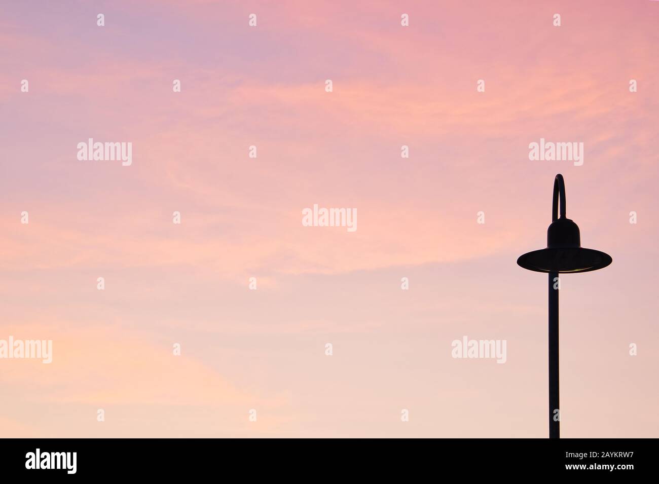 Empty red sky at sunrise with a street lamp Stock Photo