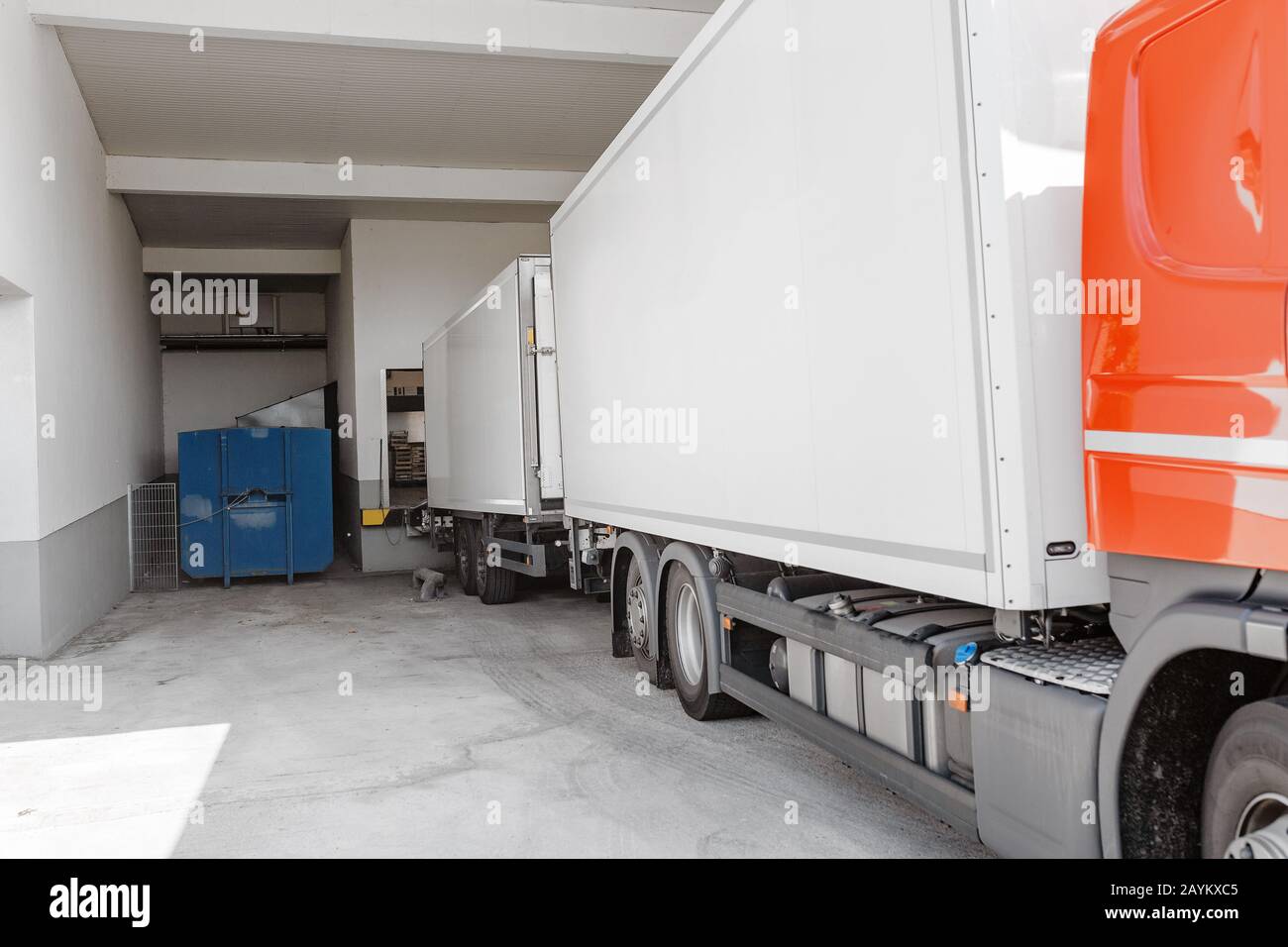 freight truck loading and unloading commercial cargo in convenience ...