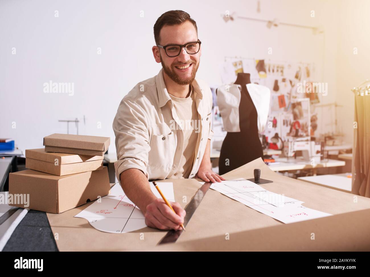 Seamstress works to new clothes ordered by internet client Stock Photo