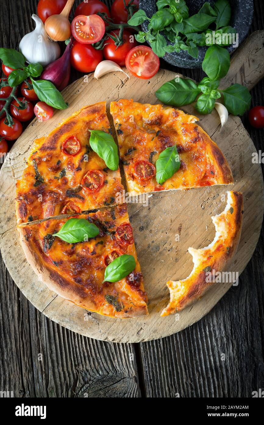 homemade pizza margherita with mozzarella, basil and tomatoes, bite off Stock Photo