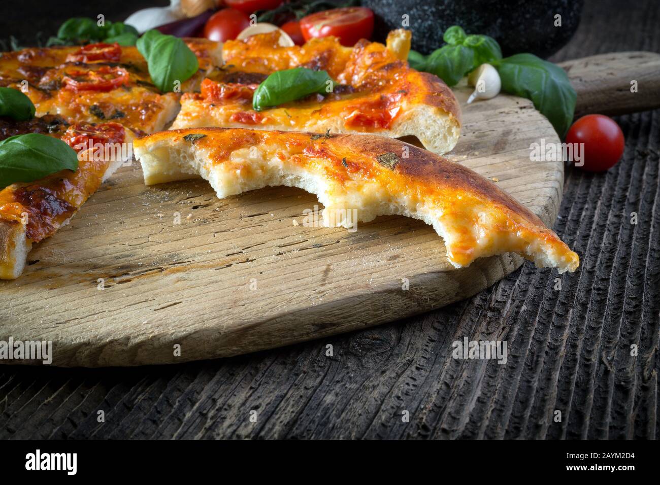 homemade pizza margherita with mozzarella, basil and tomatoes, bite off Stock Photo