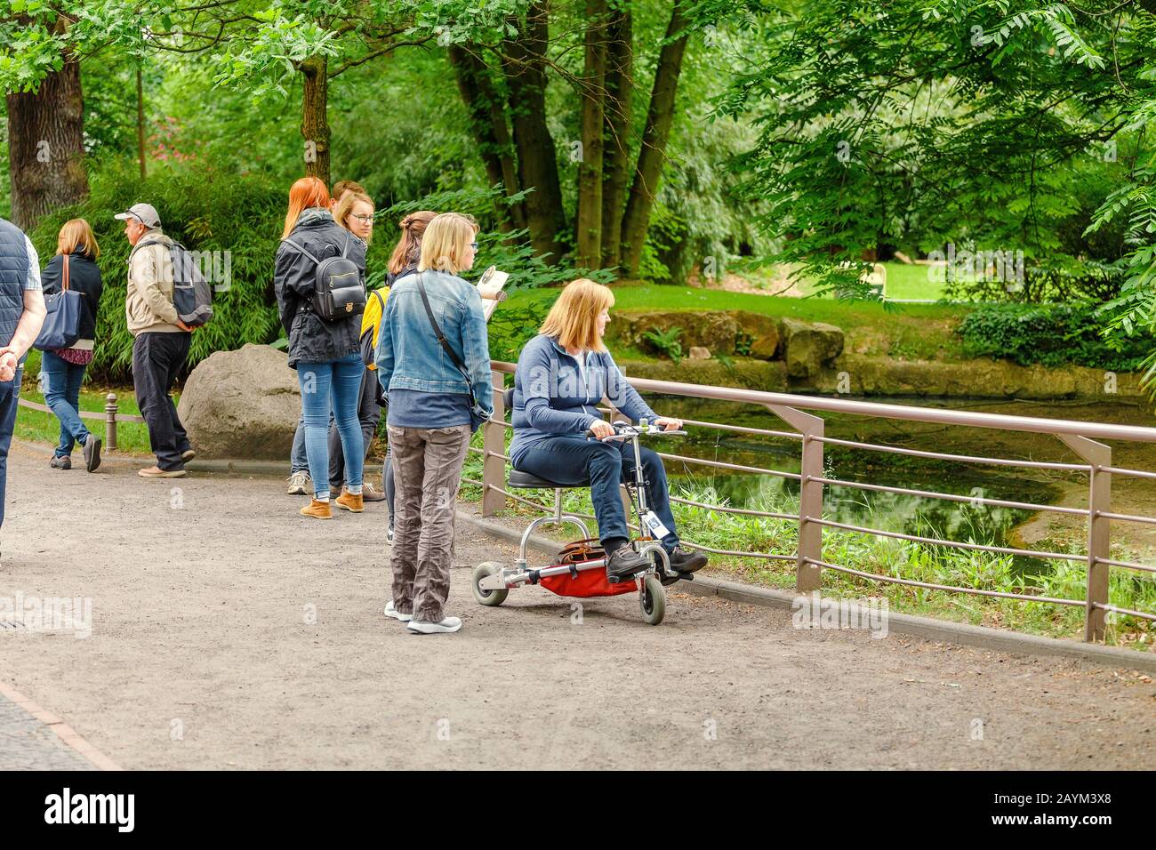 18 MAY 2018, BERLIN, GERMANY: People watching animals in the Zoo, family leisure concept Stock Photo