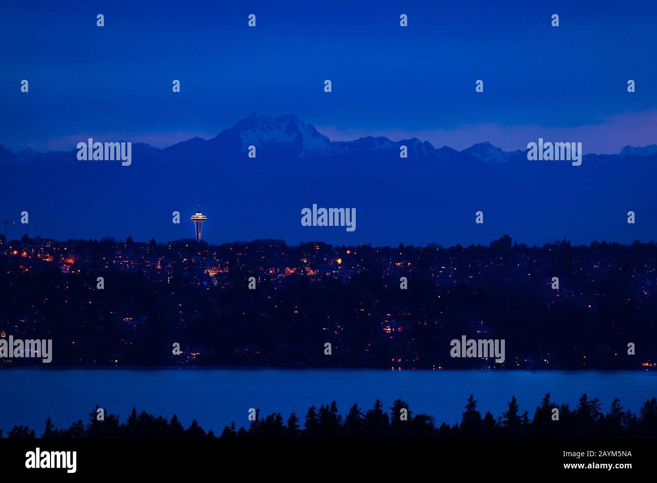 View of Seattle town at night and mountain Olympus on background with homes, lake Washington in front from Bellevue, WA, USA Stock Photo