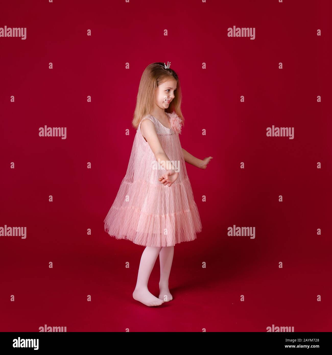 Beautiful little girl princess dancing in luxury pink and silver dress ...