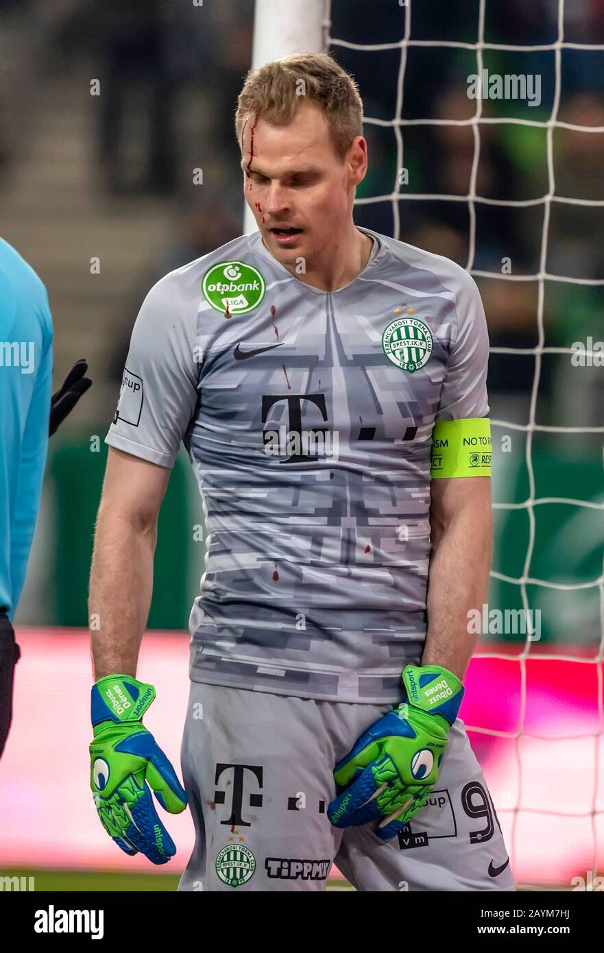 BUDAPEST, HUNGARY - FEBRUARY 15: Denes Dibusz of Ferencvarosi TC bleeds after an injury during the Hungarian OTP Bank Liga match between Ferencvarosi TC and MOL Fehervar FC at Groupama Arena on February 15, 2020 in Budapest, Hungary. Stock Photo