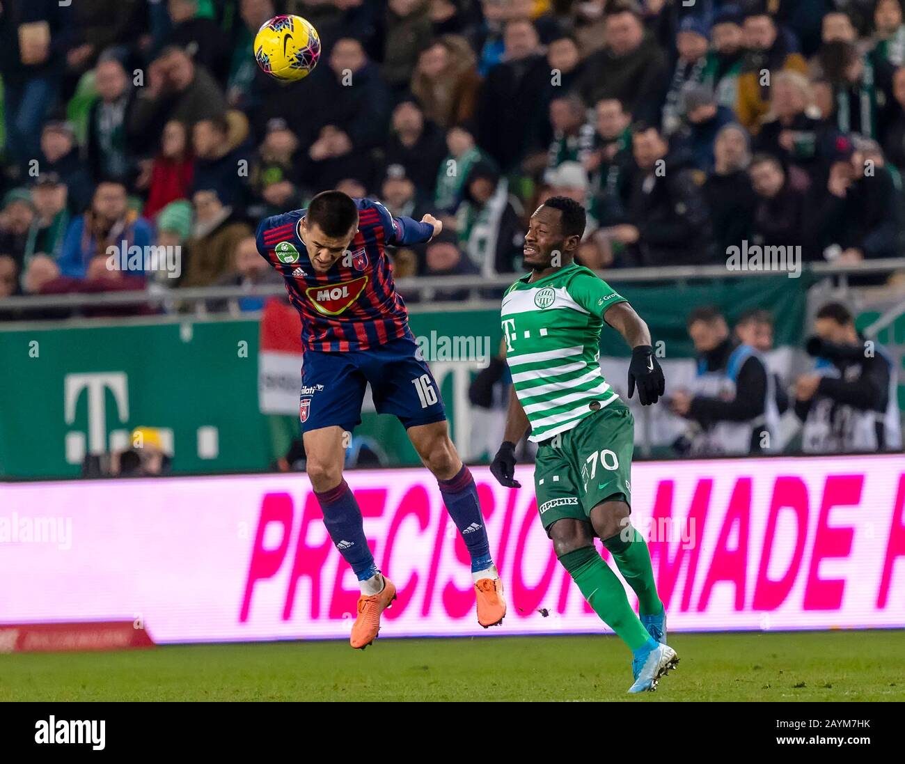 Ivan Petryak of MOL Fehervar FC dribbles between Franck Boli of