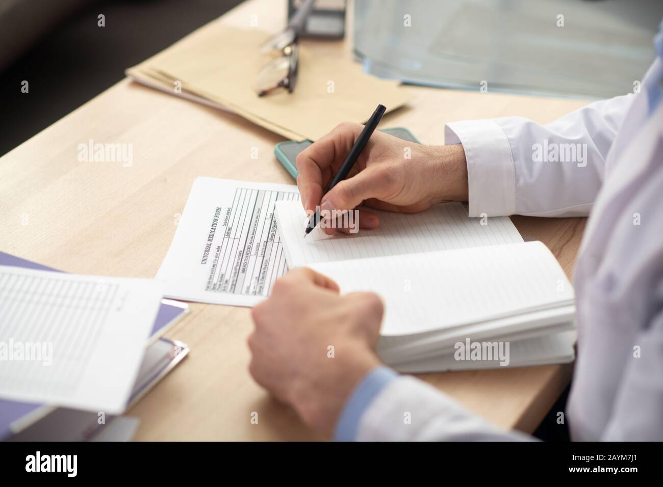 Close up picture of mans hands making notes Stock Photo - Alamy