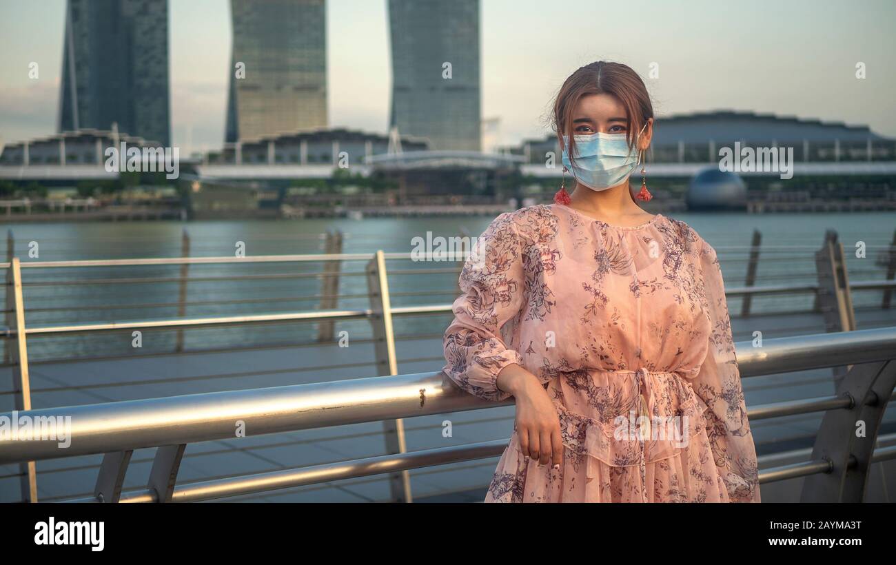 Asian Chinese girl wearing a surgical face mask to protect herself from