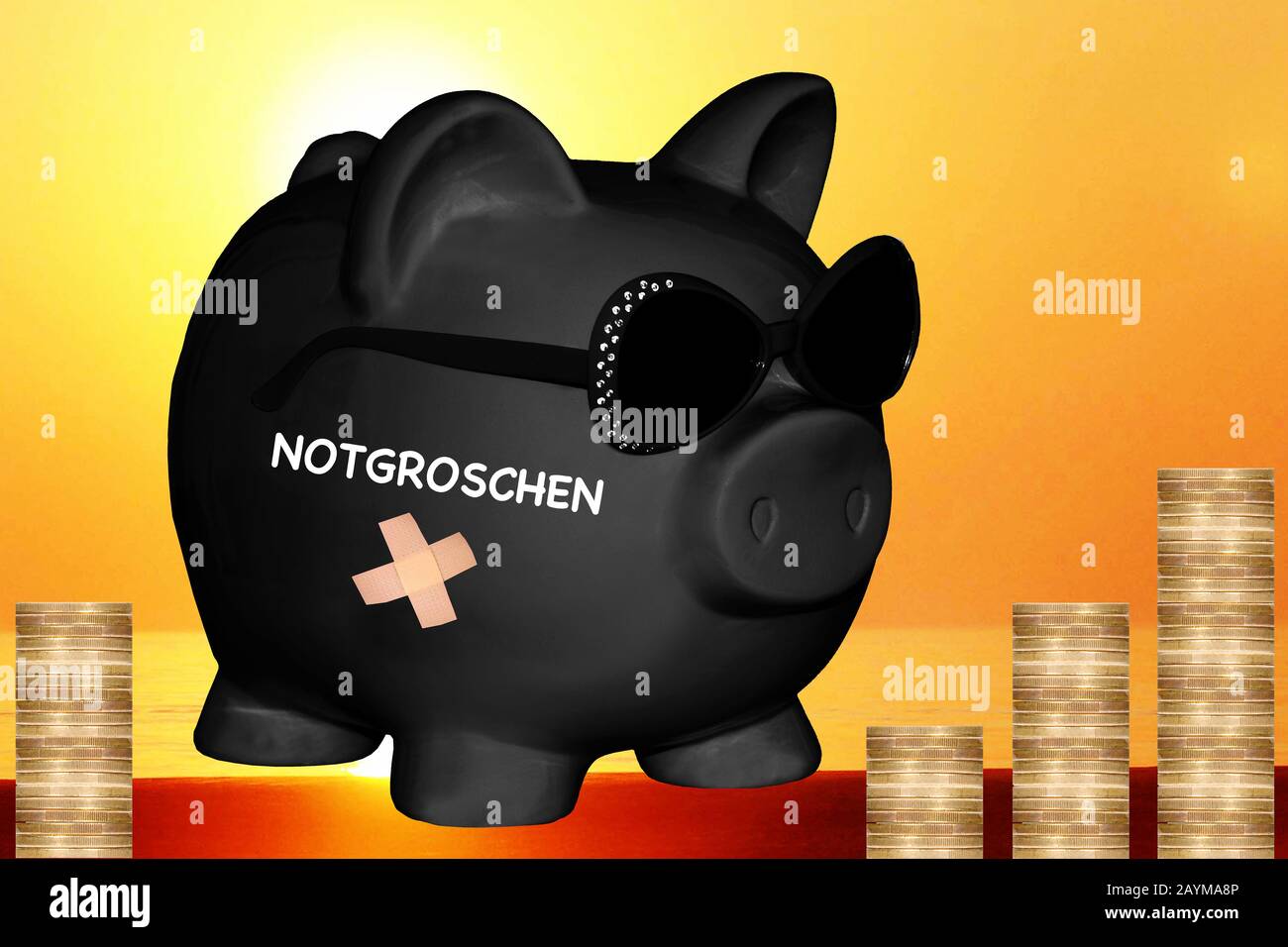 black piggy bank with sun glasses with lettering Notgroschen, nest egg, coin stacks in background, composing Stock Photo