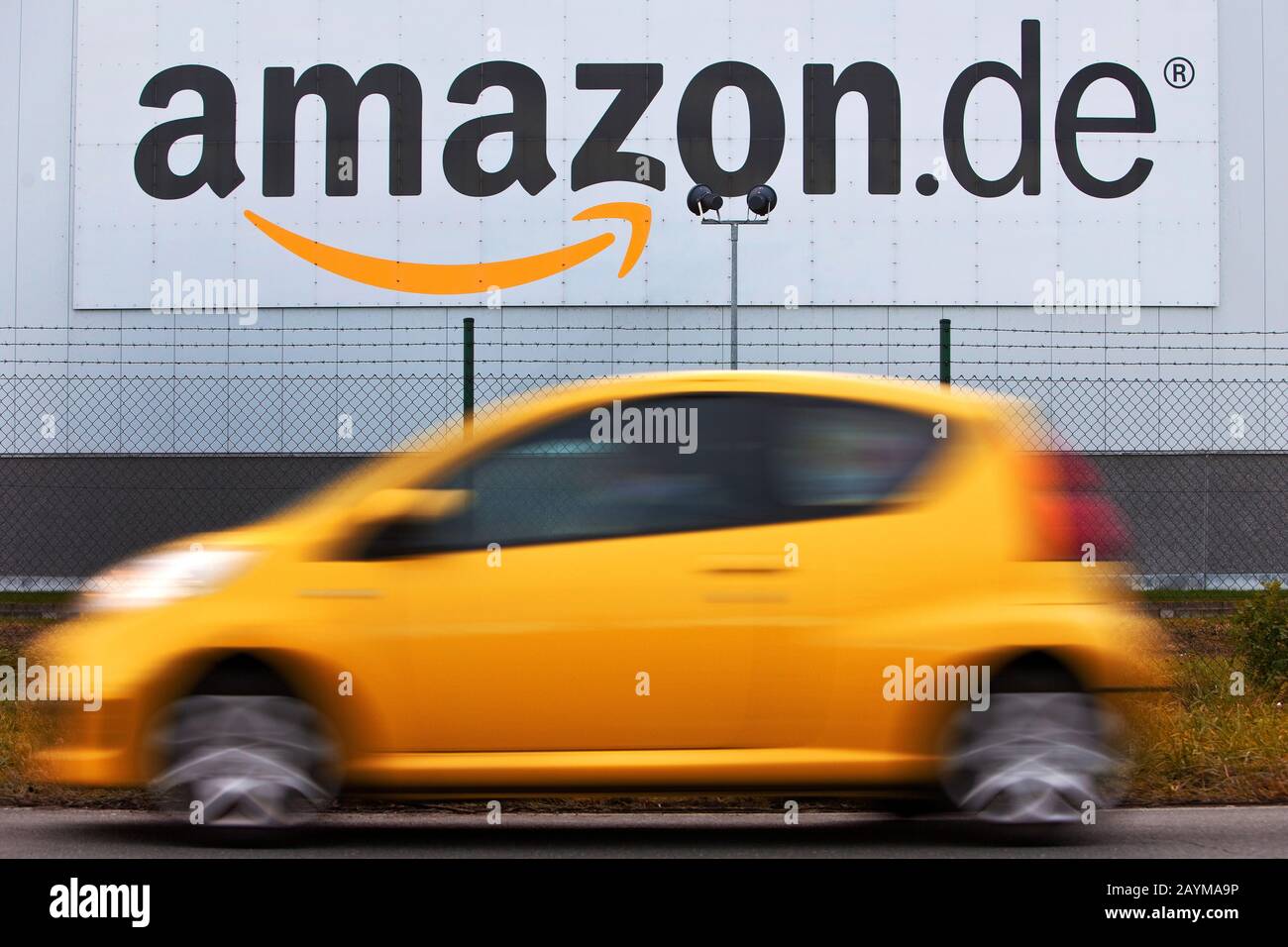 car in front of the amazon logistics centre Rheinberg, one of the largest site in Europe, Germany, North Rhine-Westphalia, Ruhr Area, Rheinberg Stock Photo