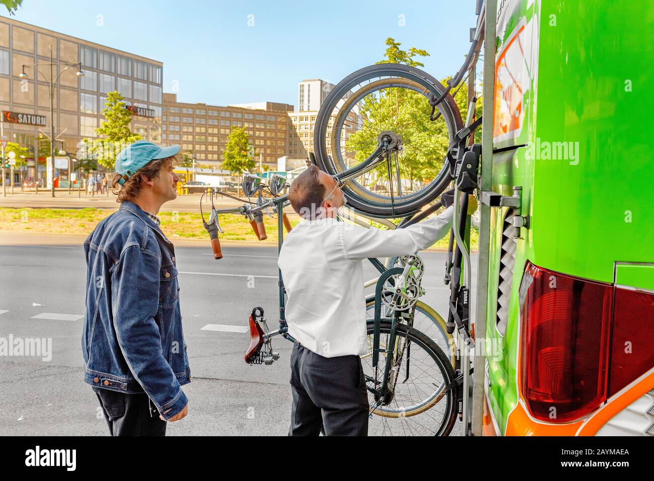 BERLIN, GERMANY, 20 MAY 2018: Driver of a FLIXBUS bus mounting and  fastening passengers bicycle to a special rack Stock Photo - Alamy