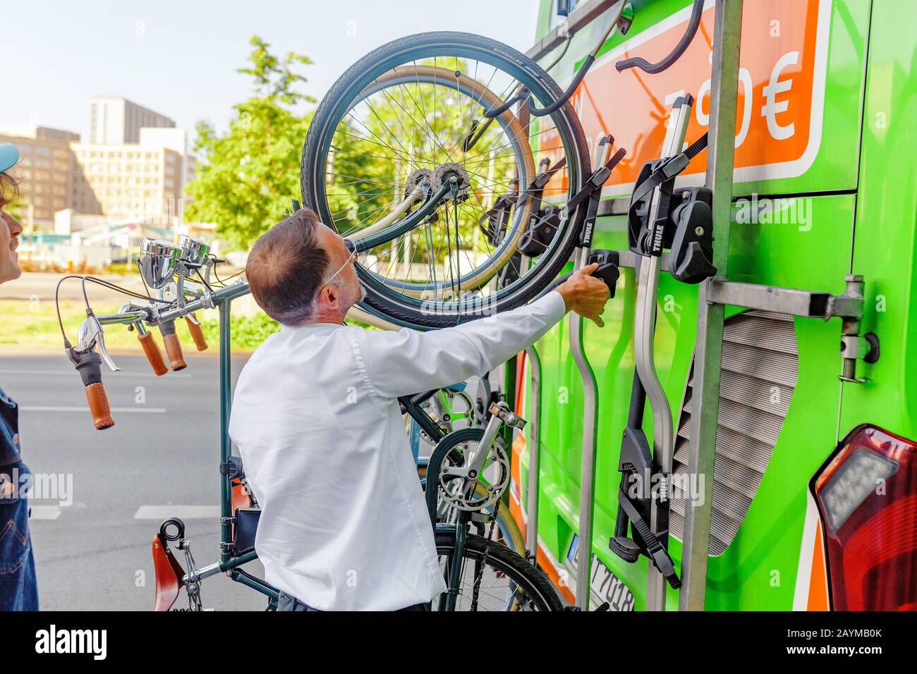 BERLIN, GERMANY, 20 MAY 2018: Driver of a FLIXBUS bus mounting and  fastening passengers bicycle to a special rack Stock Photo - Alamy