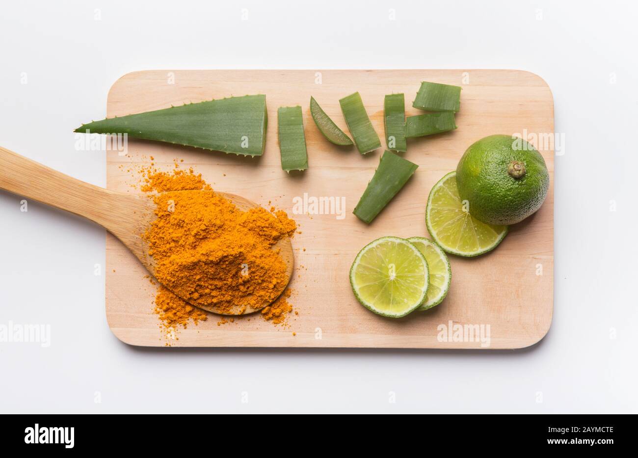 Turmeric powder on spoon and slice lime with Aloe Vera slice Stock Photo -  Alamy