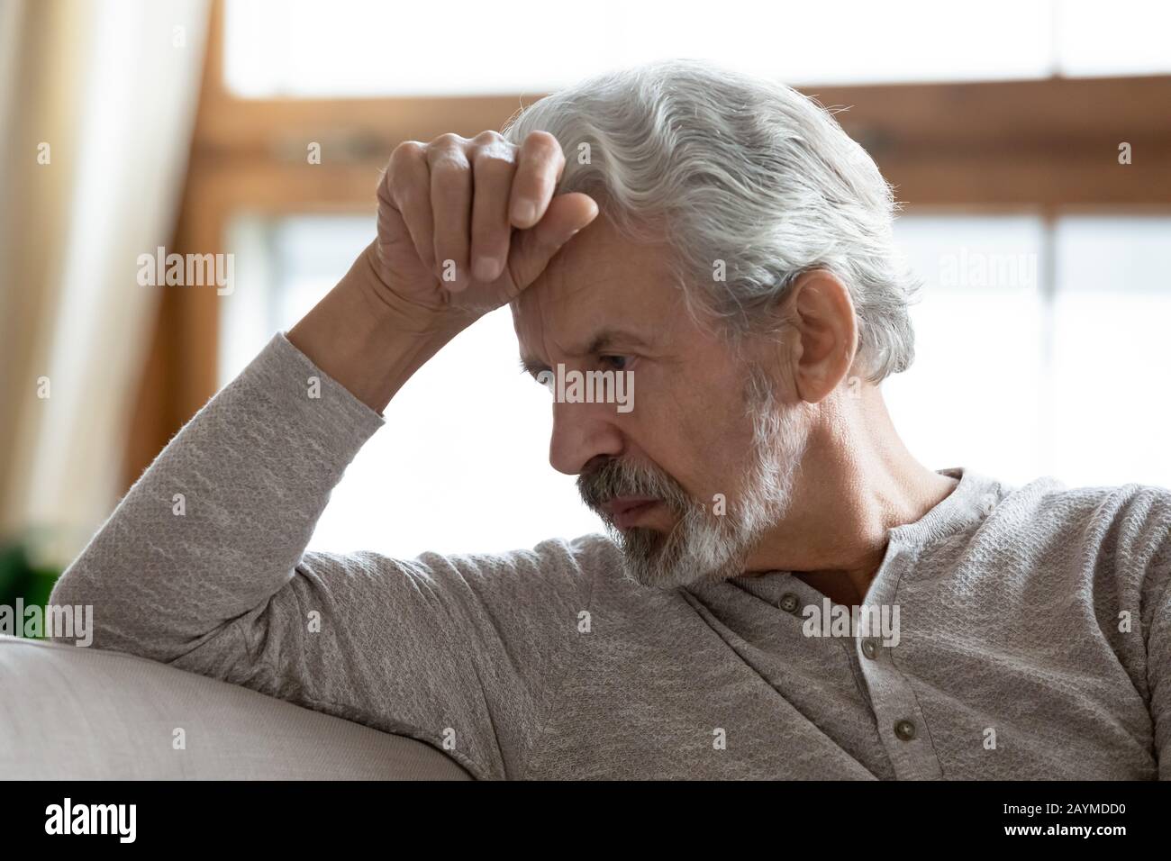 Depressed mature elderly hoary man lost in bad thoughts. Stock Photo