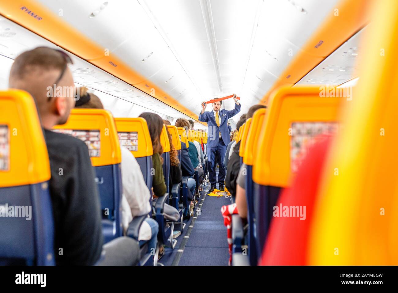 16 MAY 2018, BUDAPEST HUNGARY: Passengers seating and listening to the crew members steward safety instructions inside the Ryanair airlines plane Stock Photo
