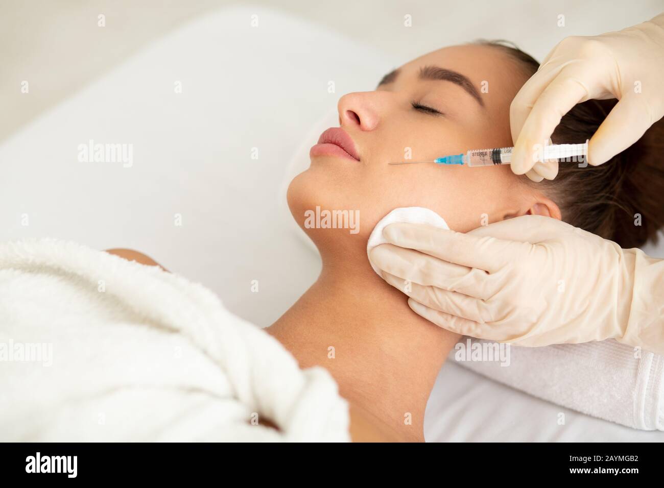Woman receiving anti wrinkle injection in beauty clinic Stock Photo