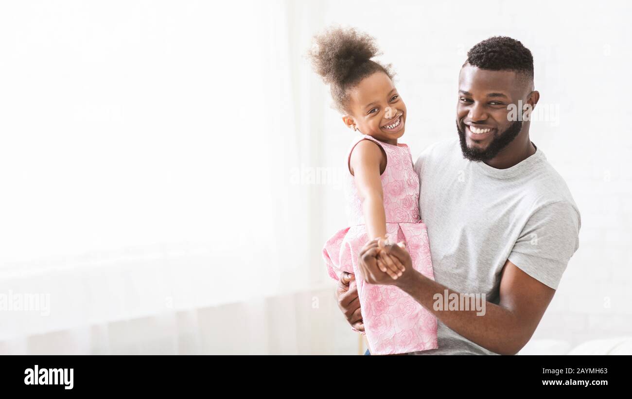 African young father holding his beautiful little daughter Stock Photo ...
