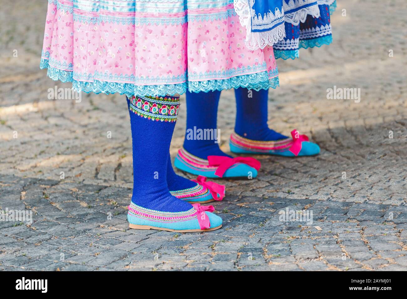 Woman at the Slovak traditional folklore festival is wearing traditional Eastern Europe folk costumes and footwear Stock Photo