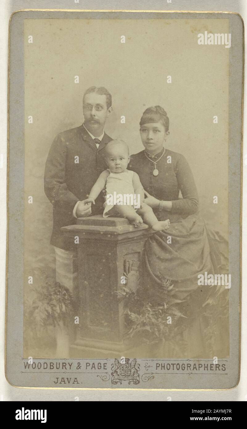 Studio portrait of a family consisting of a Dutch man, a Javanese woman and a baby, Woodbury & Page, 1890 - 1915.jpg - 2AYMJ7R Stock Photo