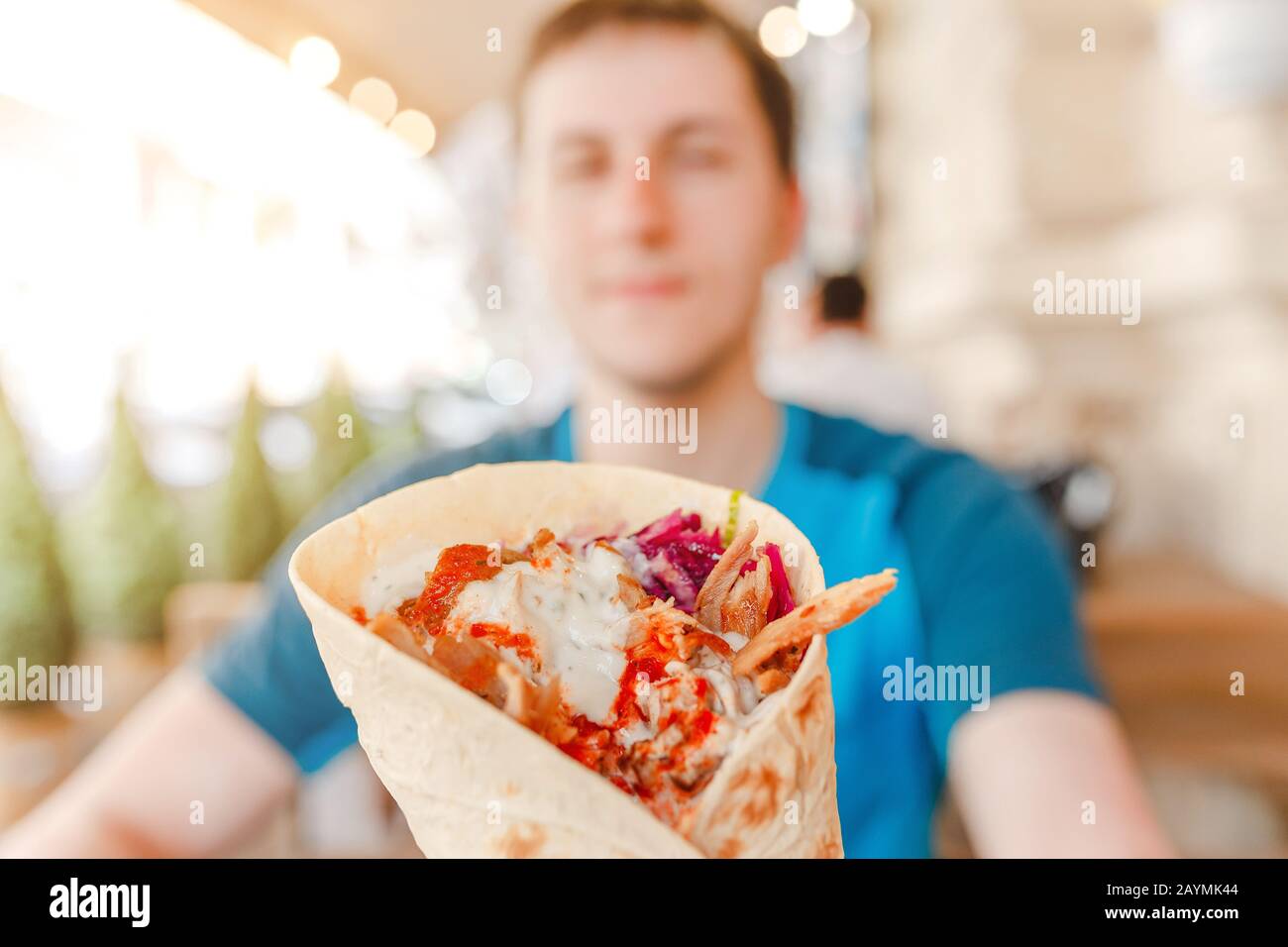 Man eating Doner Kebap its a midlle eastern fast food cuisine Stock Photo