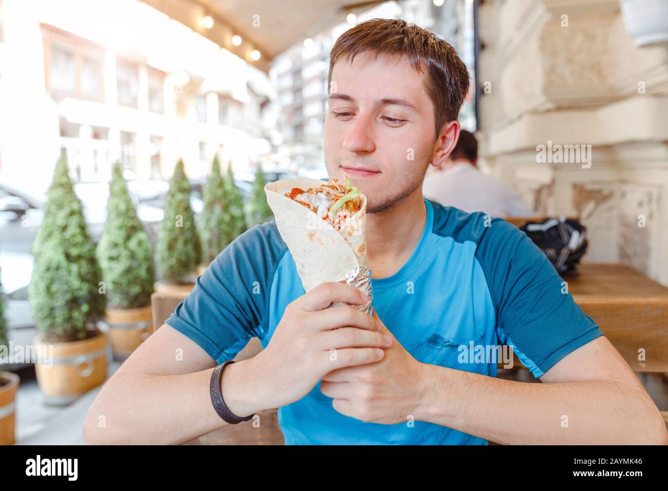 Man eating Doner Kebap its a midlle eastern fast food cuisine Stock Photo