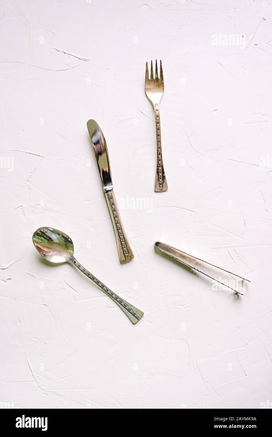 Vintage cutlery on a white background. Silver spoon, fork, knife and