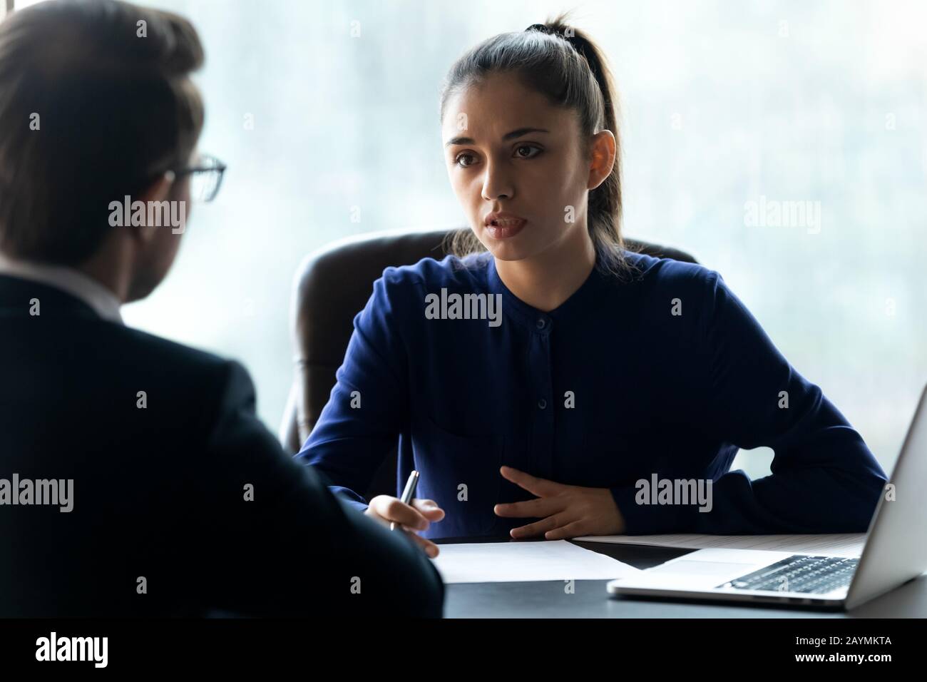 Attractive businesswoman hr interviewing new applicant using cv and laptop. Stock Photo