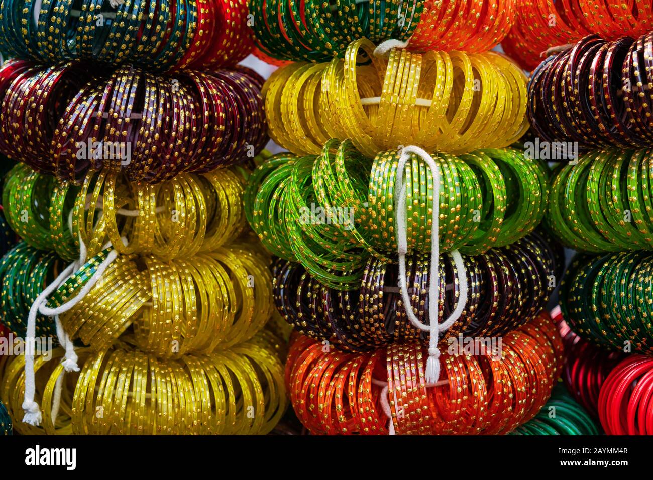 Bunches of Indian glass bangles in bright colors being sold along open street in Udaipur, Rajasthan, India. Stock Photo