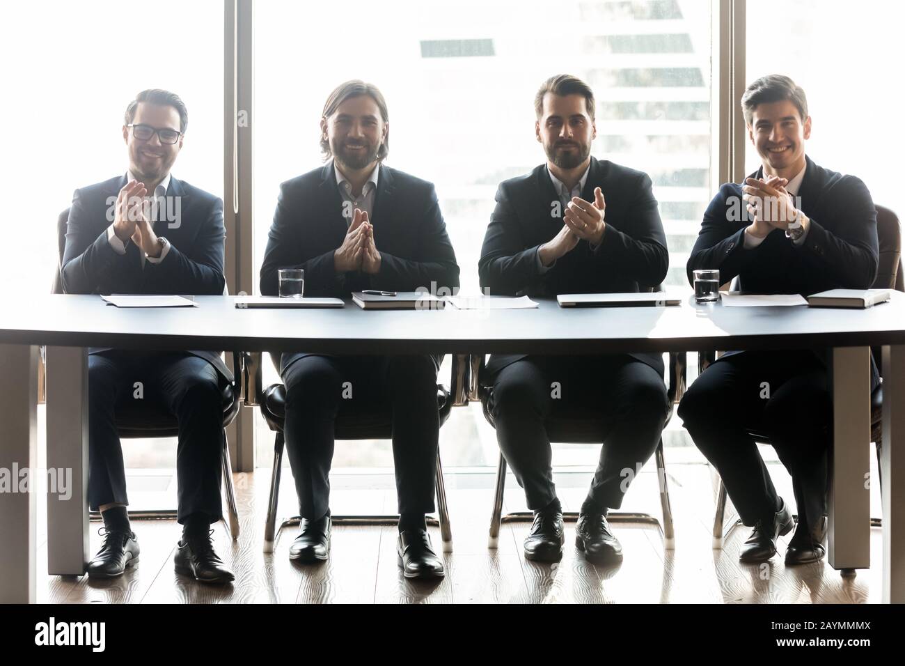 Happy businessmen with applicant resume clap hands for job. Stock Photo