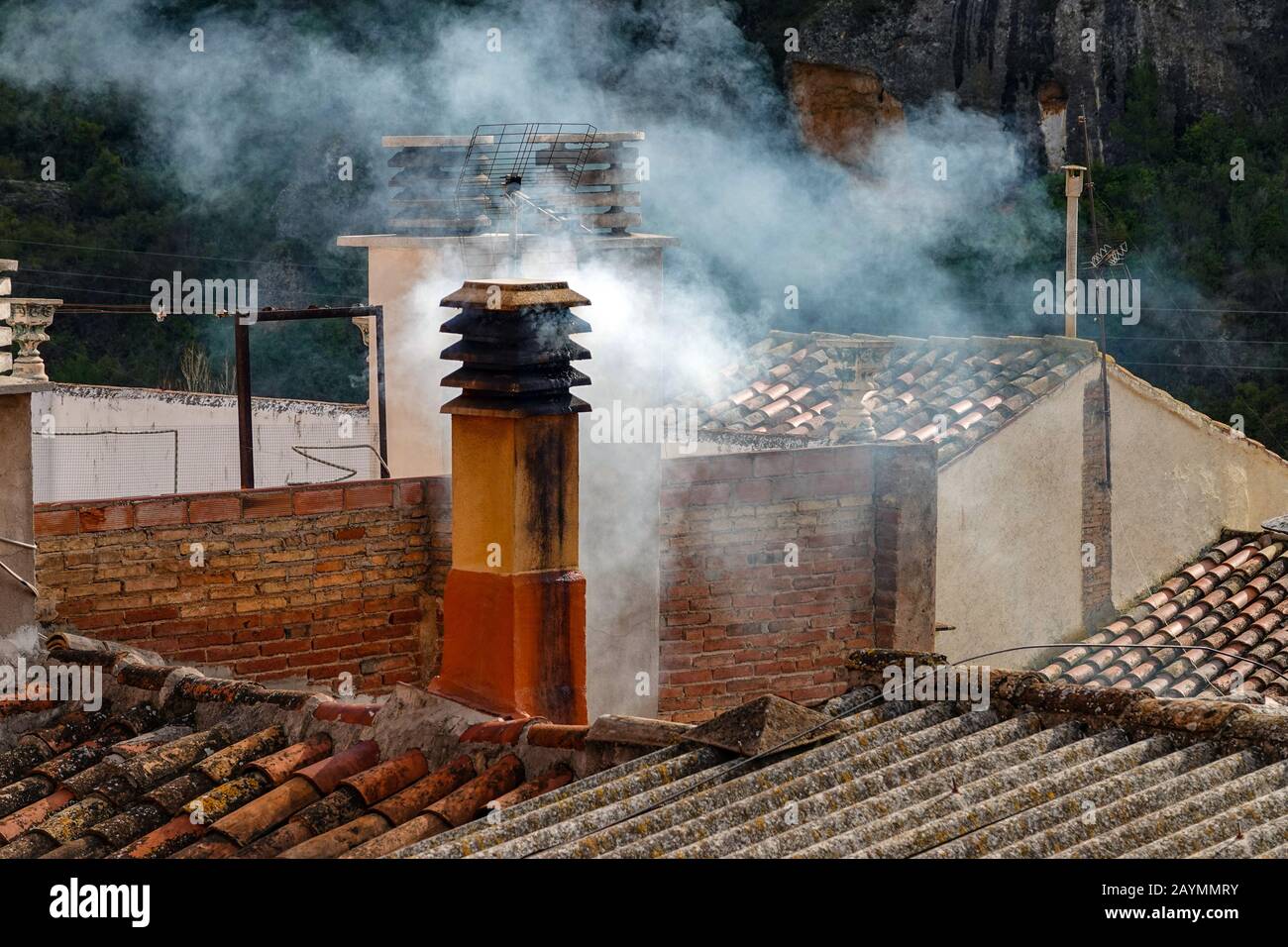 Pollutions from smokey chimney from burning wood at Margalef, Catalunya, Spain Stock Photo