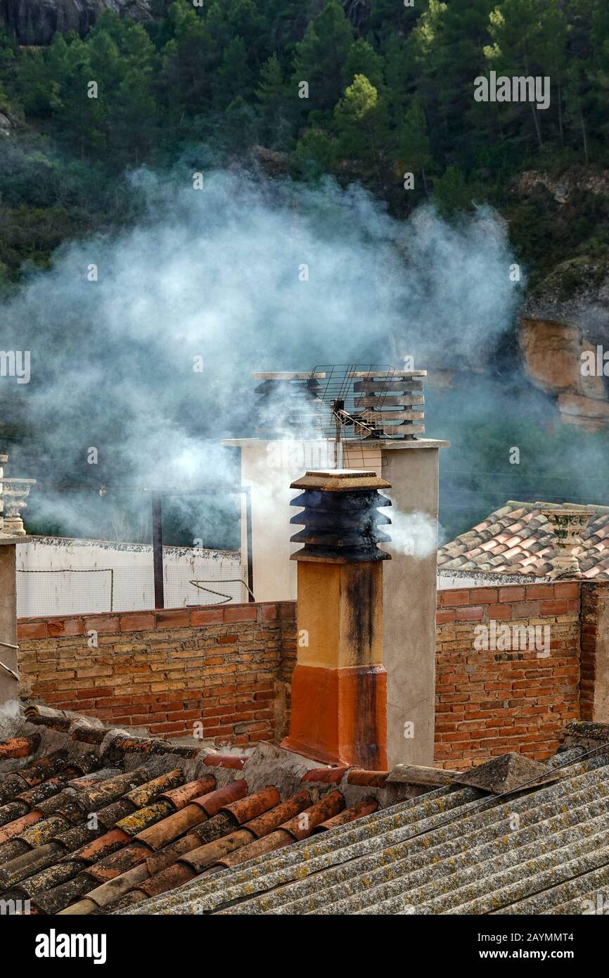 Pollutions from smokey chimney from burning wood at Margalef, Catalunya, Spain Stock Photo