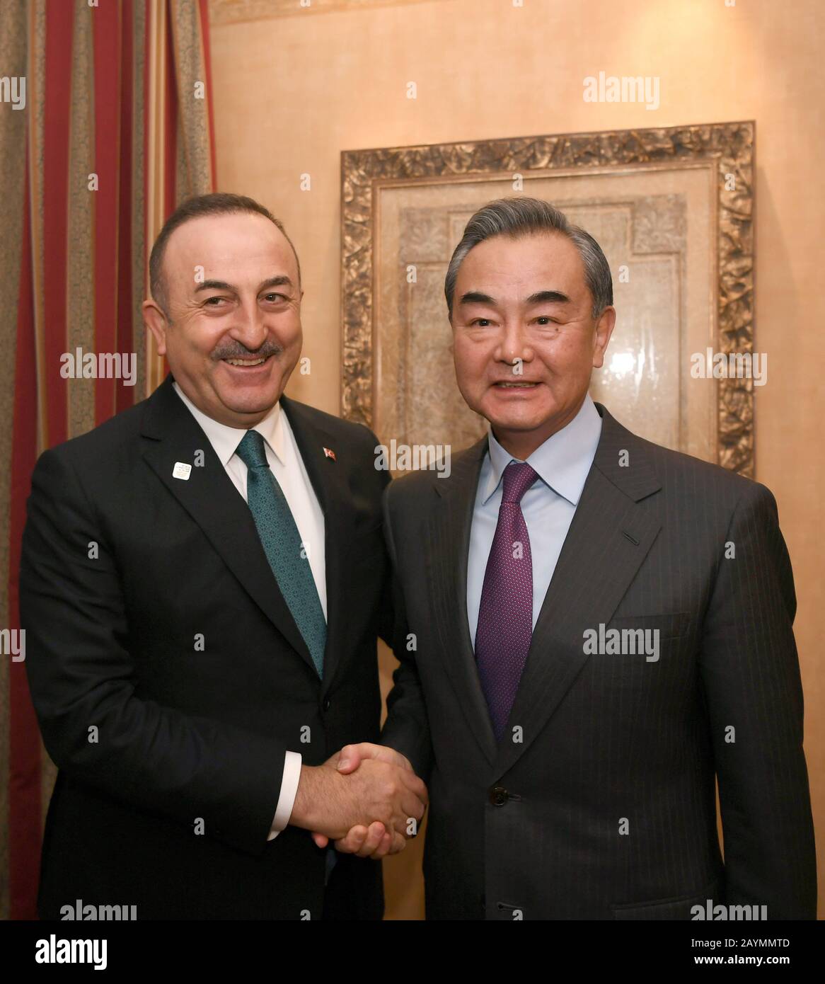 Munich, Germany. 15th Feb, 2020. Chinese State Councilor and Foreign Minister Wang Yi (R) meets with Turkish Foreign Minister Mevlut Cavusoglu, on the sidelines of the 56th Munich Security Conference in Munich, Germany, Feb. 15, 2020. Credit: Lu Yang/Xinhua/Alamy Live News Stock Photo