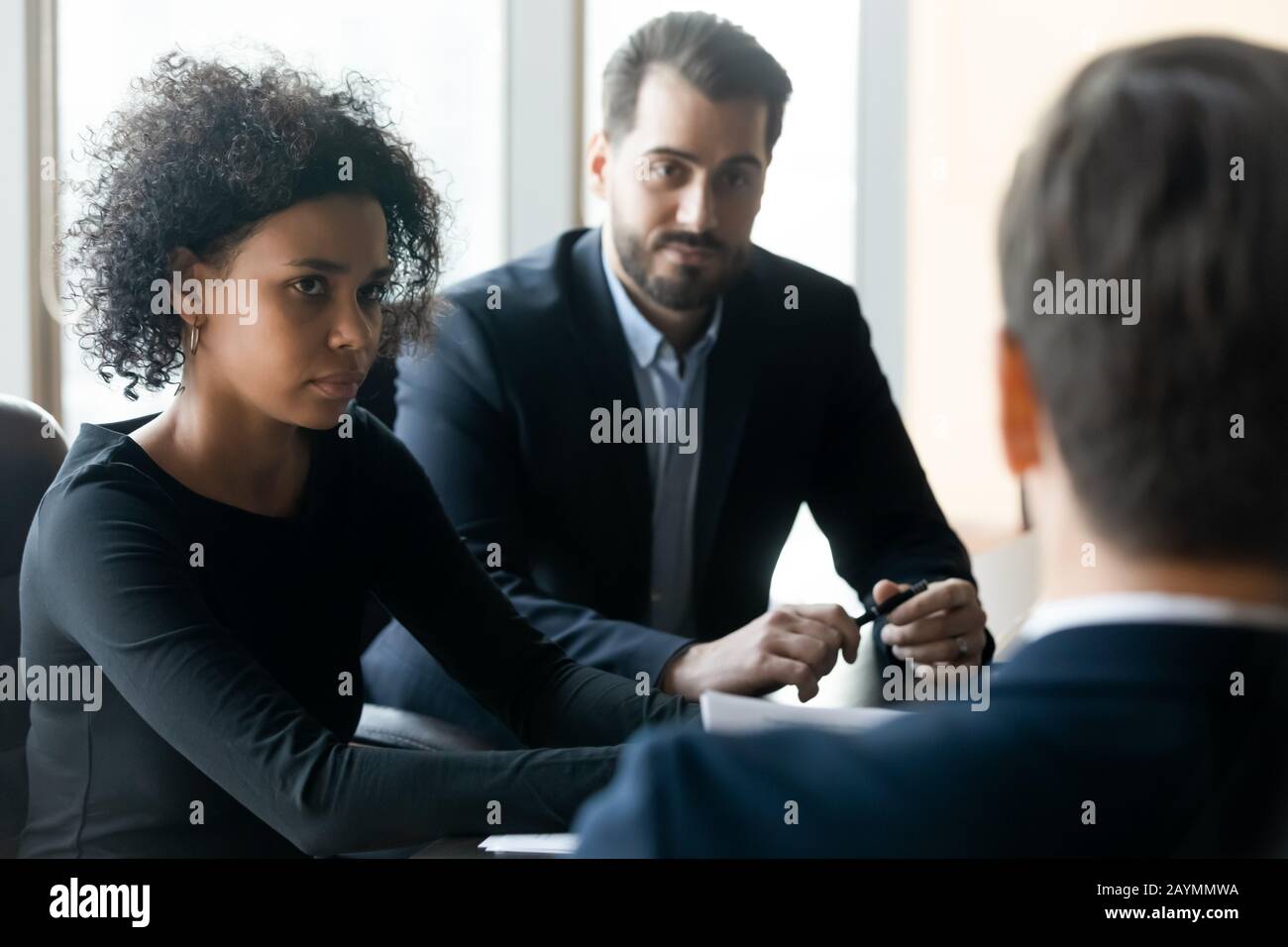 Serious african american businesswoman with colleague listening leader coaching. Stock Photo