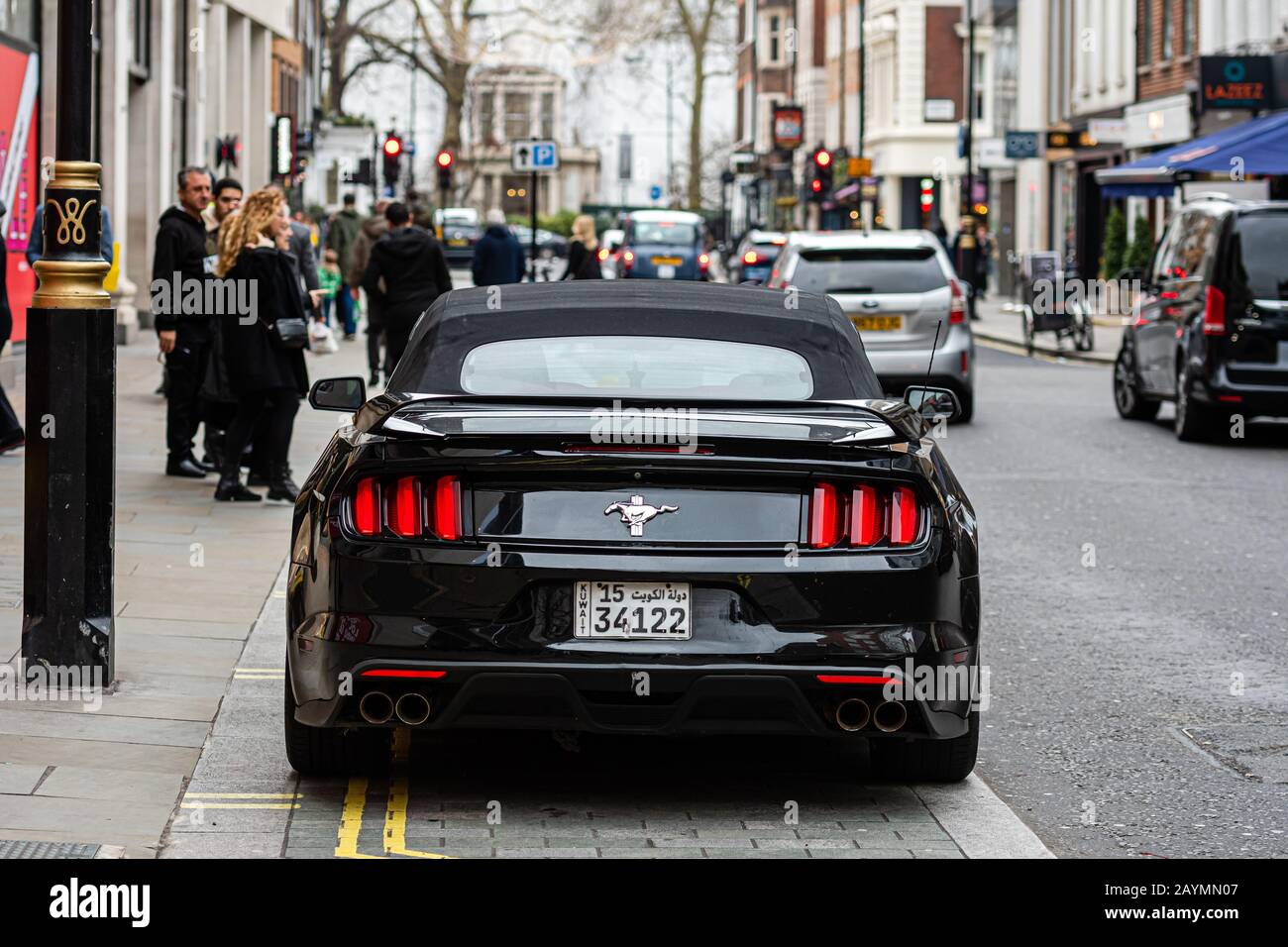 London, England, UK - January 2, 2020: a black, expensive sports muscle car parked on the edge of a city street Stock Photo