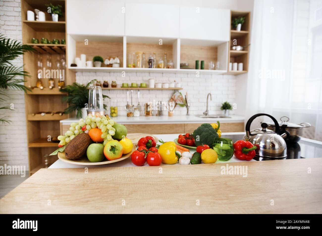 https://c8.alamy.com/comp/2AYMN48/kitchen-interior-fresh-fruits-and-vegetables-on-table-2AYMN48.jpg