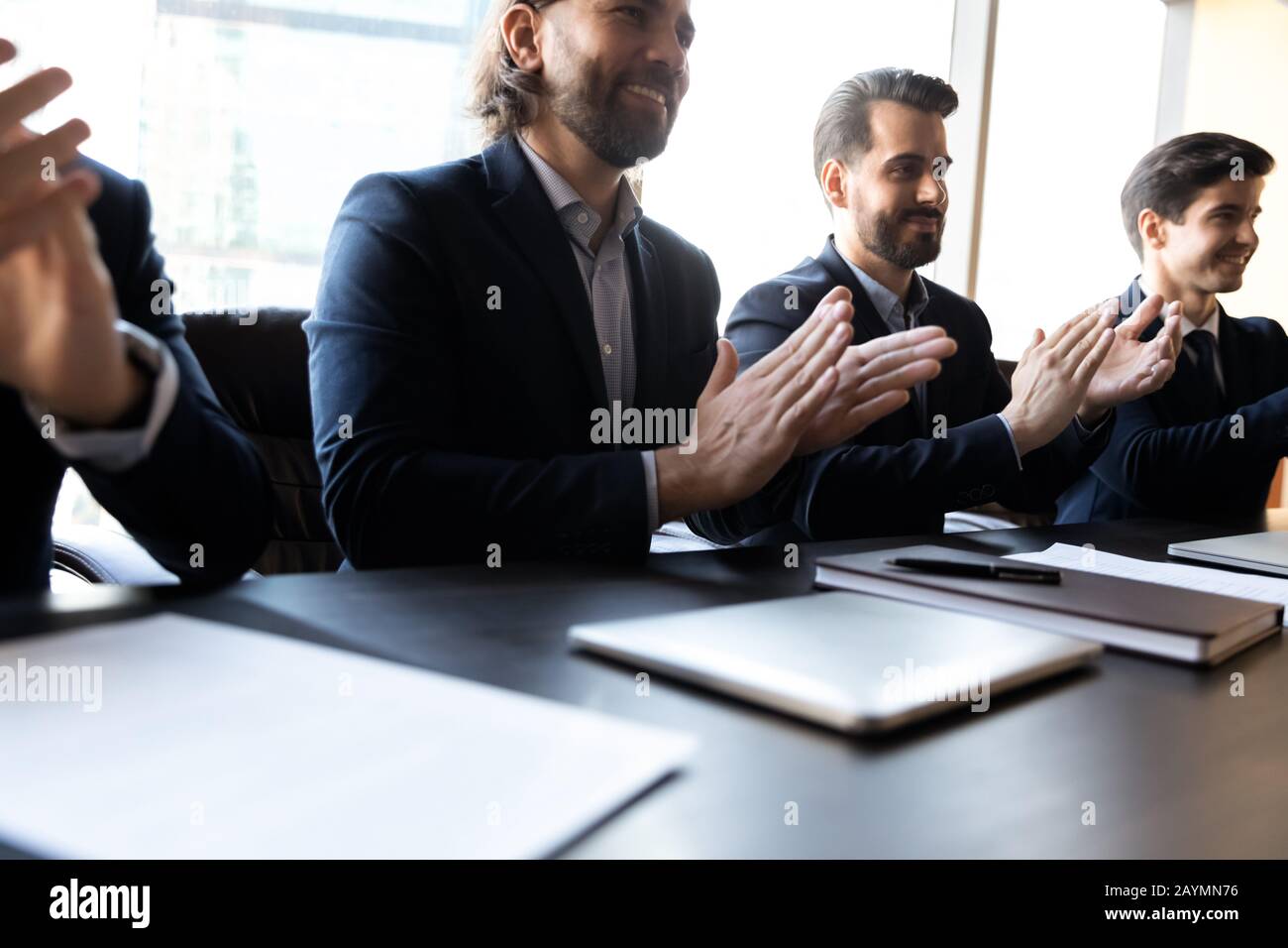 Close up happy clap hands businessmen with applicant cv. Stock Photo