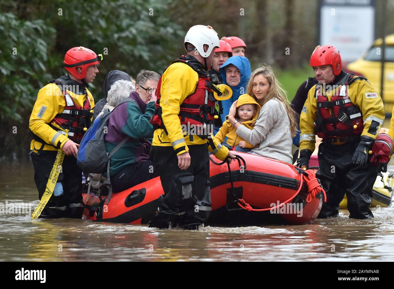 One-year-old Blake and his mum, Terri O'Donnel, join other residents of Nantgarw in a rescue boat as emergency services take people to safety, after flooding in the village in Wales as Storm Dennis hit the UK. Stock Photo