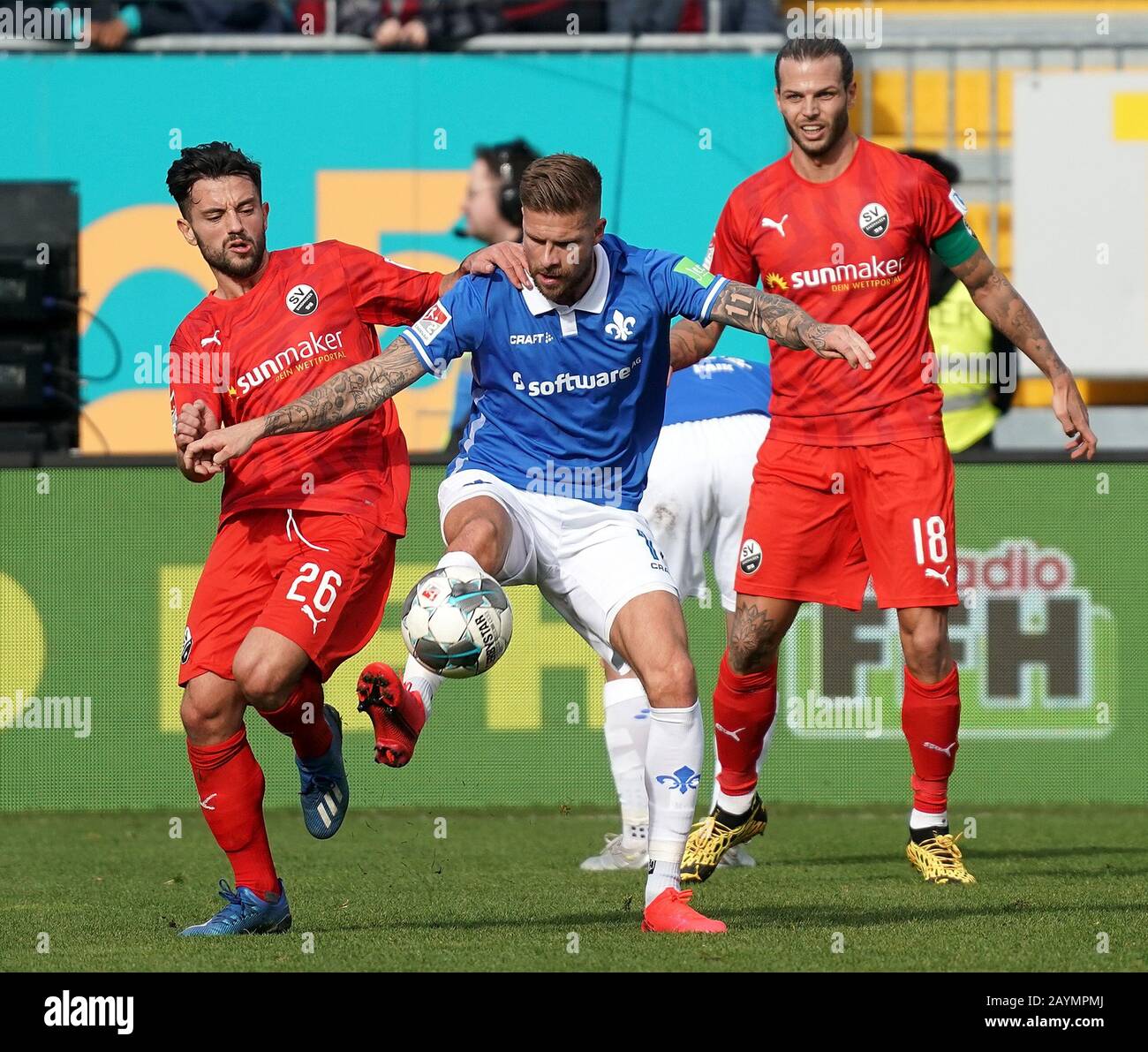 Darmstadt, Germany. 16th Feb, 2020. Football: 2nd Bundesliga, Darmstadt 98 - SV Sandhausen, 22nd matchday in the Merck Stadium: Darmstadt's Tobias Kempe (M) secures the ball against Dennis Diekmeier (r) and Besar Halimi (l) from Sandhausen. Credit: Hasan Bratic/dpa - IMPORTANT NOTE: In accordance with the regulations of the DFL Deutsche Fußball Liga and the DFB Deutscher Fußball-Bund, it is prohibited to exploit or have exploited in the stadium and/or from the game taken photographs in the form of sequence images and/or video-like photo series./dpa/Alamy Live News Stock Photo