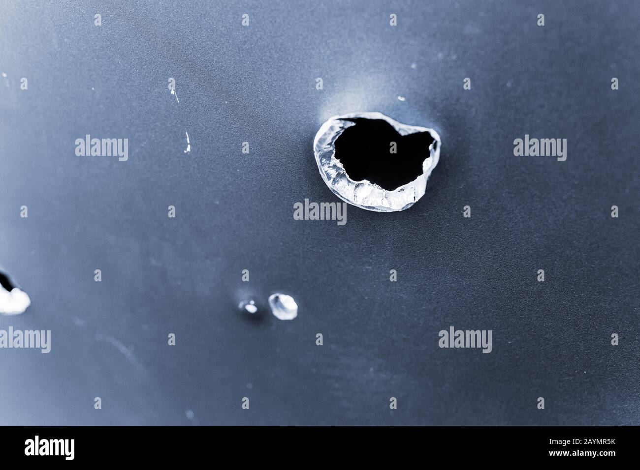 bullet hole in armored metal plate, war conflict and military tragedy concept Stock Photo