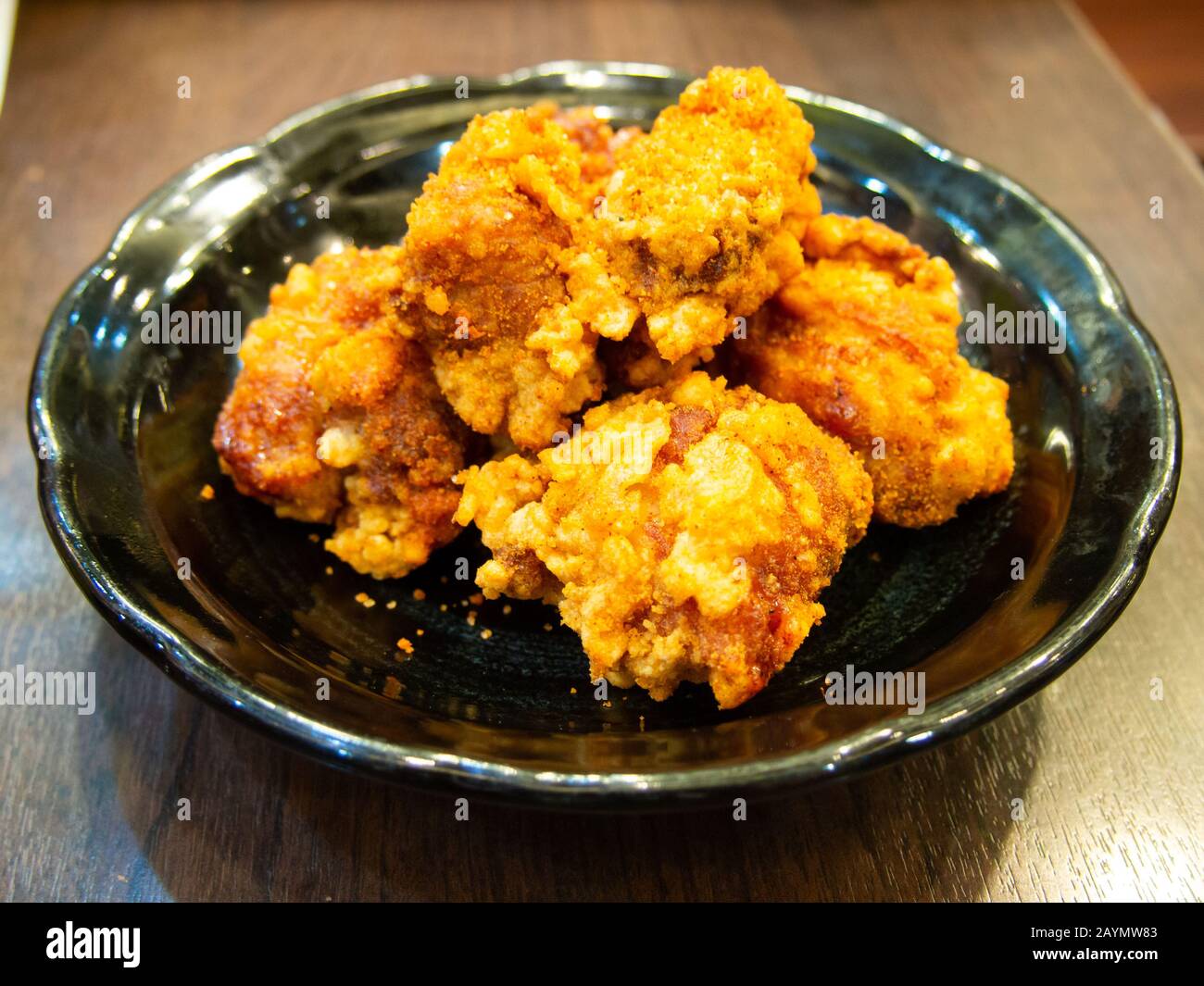 Fried chicken in Japanese style (karaage) in black plate background