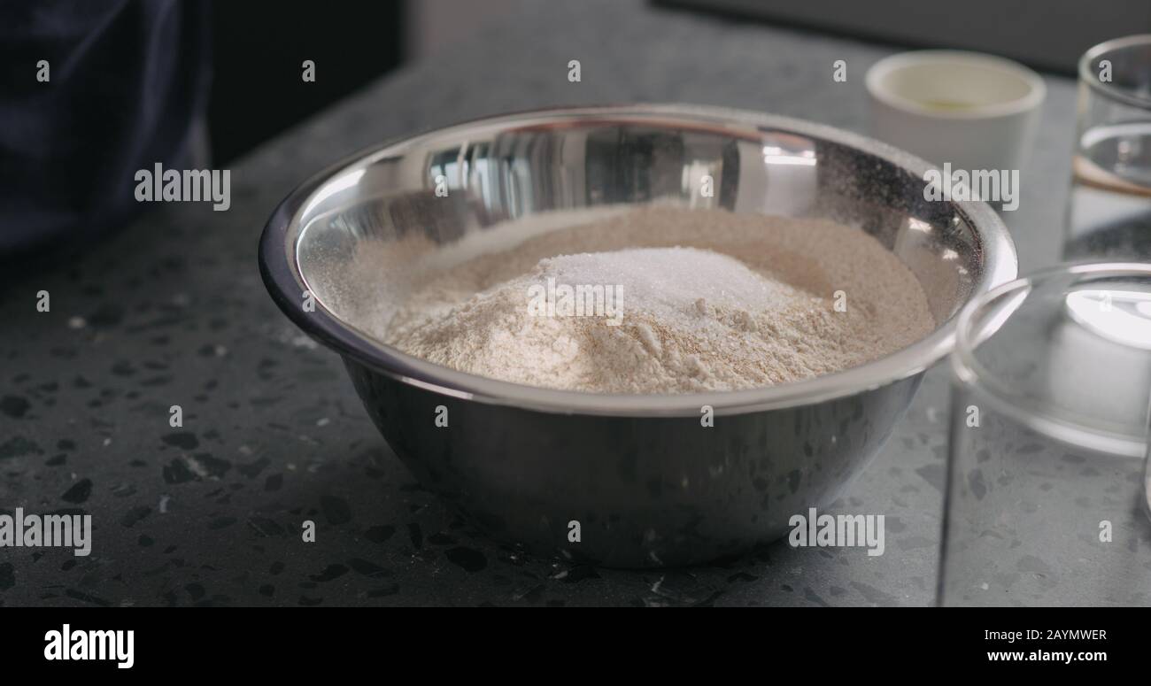 Add Dry Ingredients Into Flour In Steel Bowl On Concrete