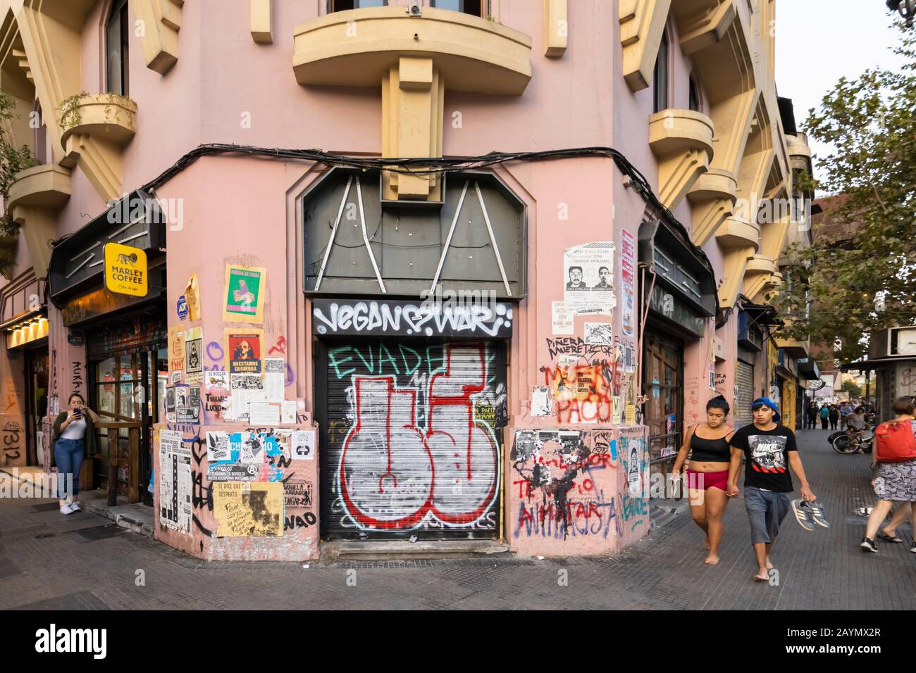 Graffiti and posters from the political unrest and protests on a shuttered shop in Lastarria, Central Santiago, Metropolitan Region, capital of Chile Stock Photo